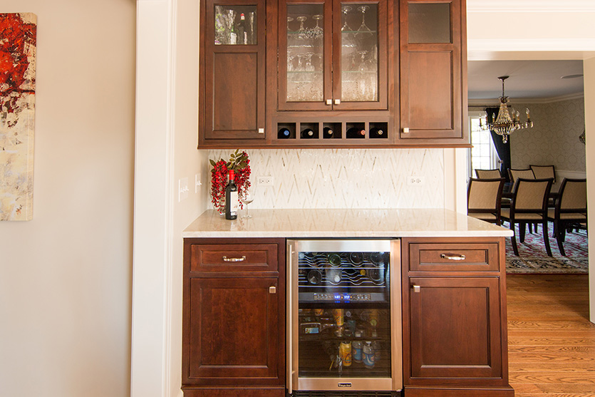 Beverage bar with dark wood cabinetry and wine fridge