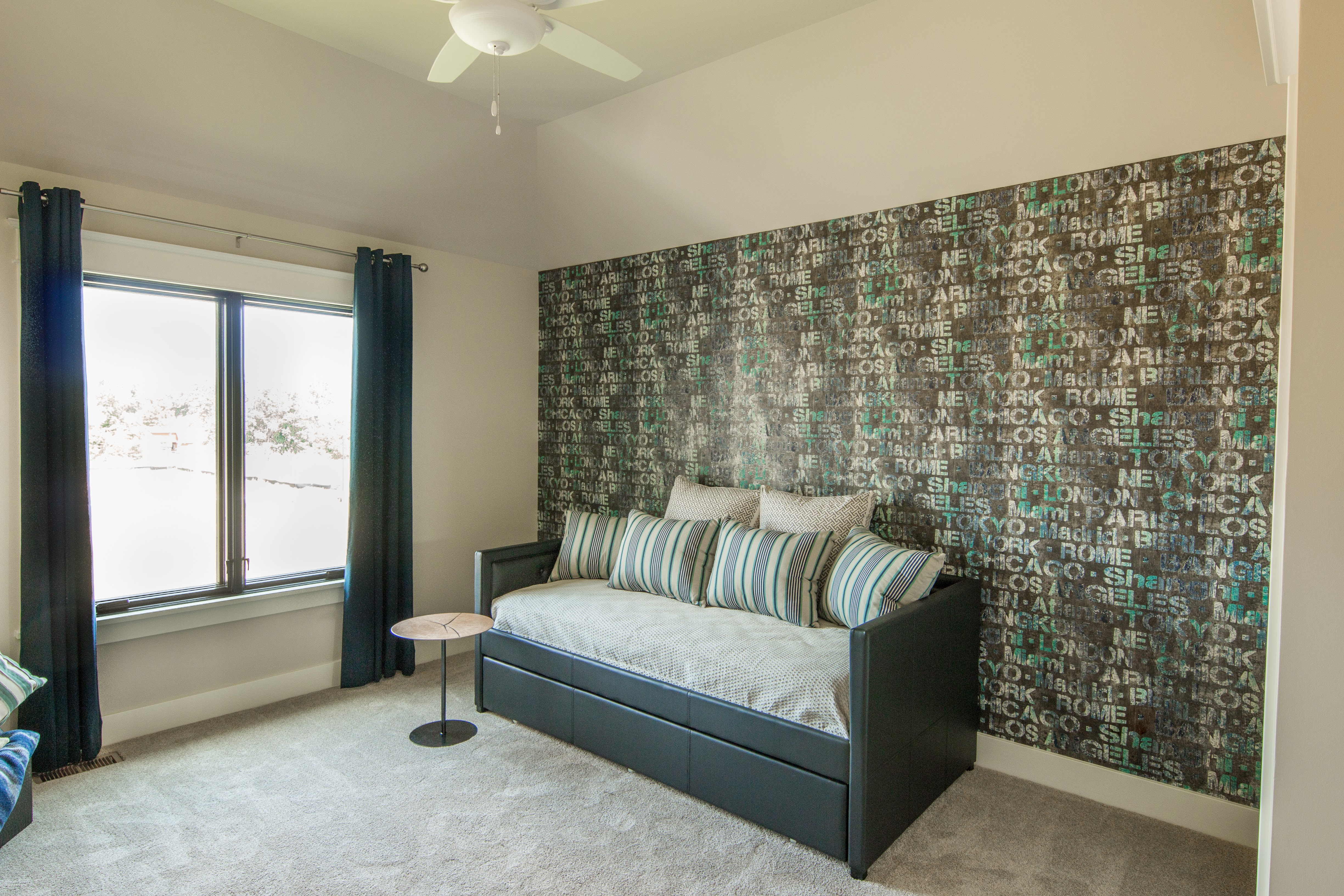 Media room with leather day bed and modern wallpaper