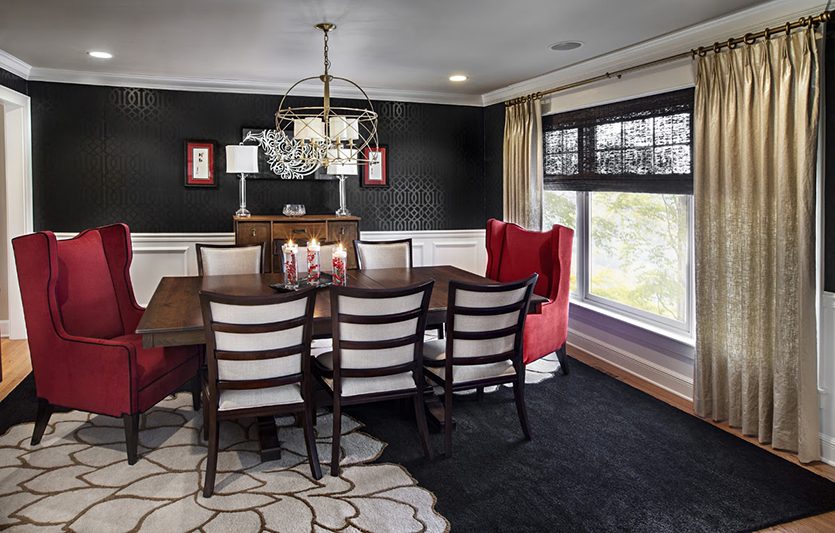 Dining room with black wallpaper and red upholstered chairs