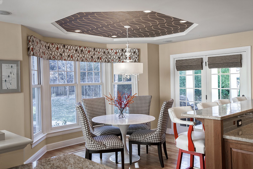Eating area with wallpaper ceiling accent and houndstooth chairs