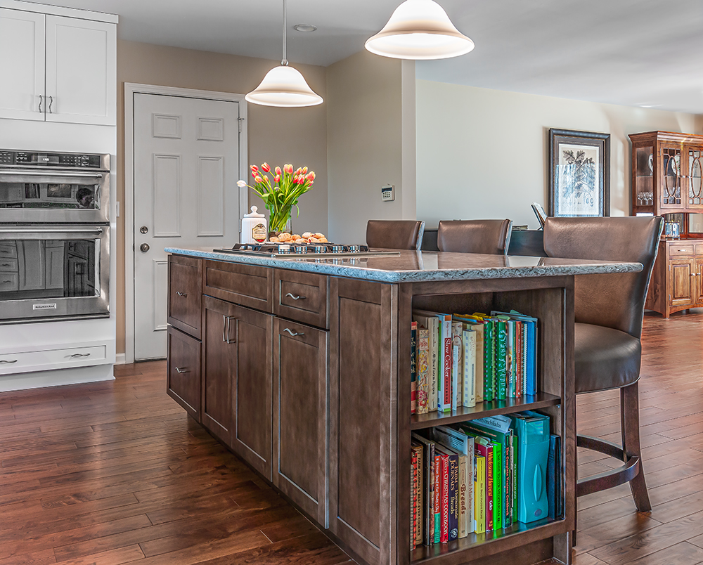 Dark kitchen island with bookcases on the ends