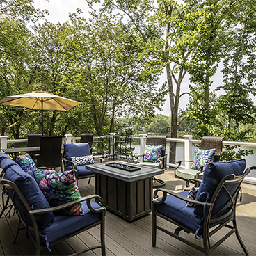 lakehouse deck with deck furniture and umbrella