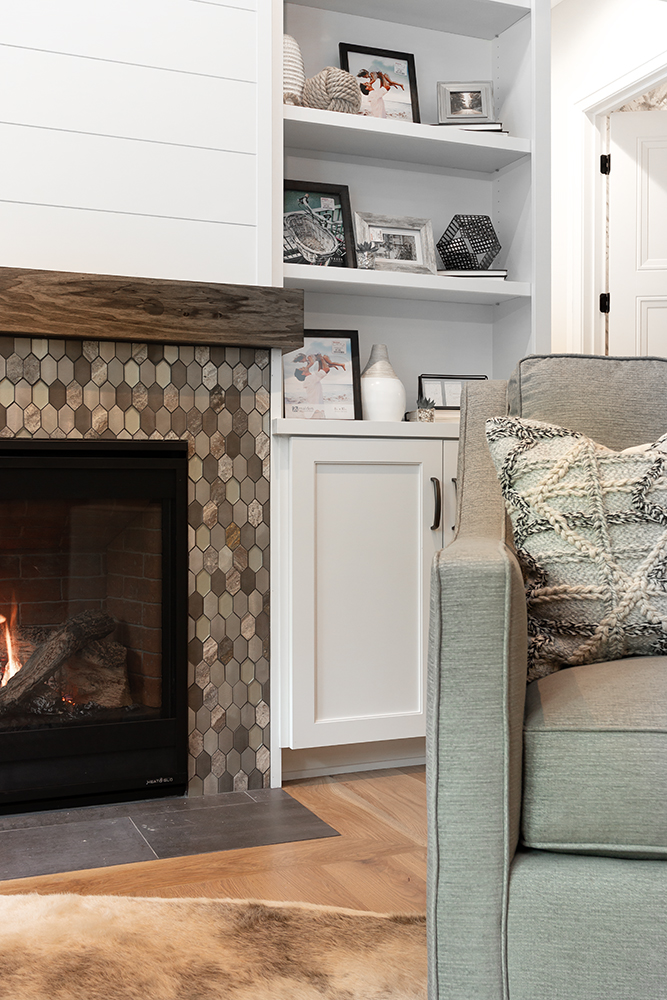 Tiled fireplace surround with dark wood and white shiplap