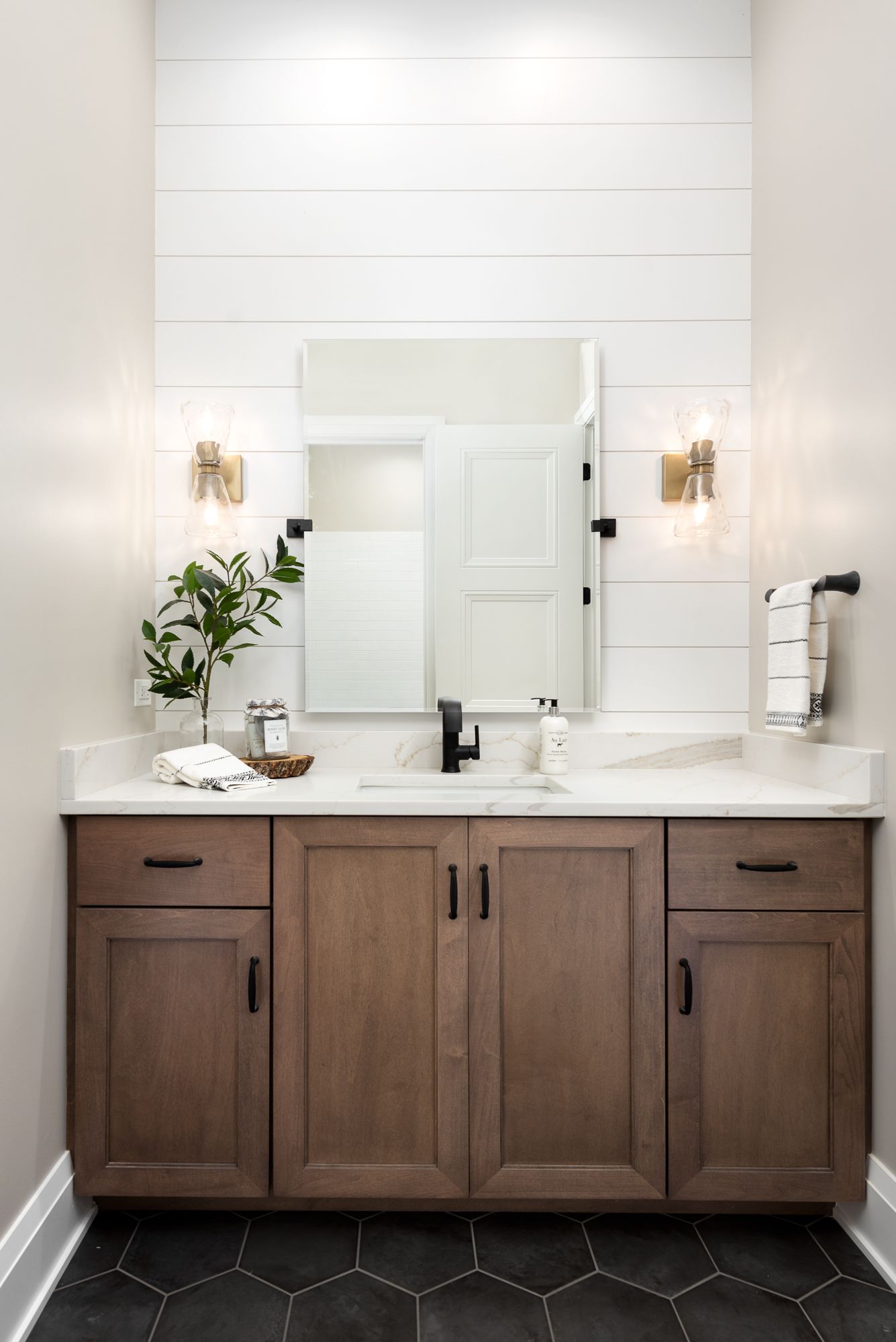 Bathroom with white shiplap and wood vanity