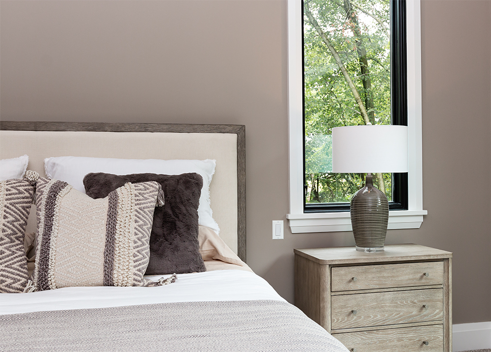Master bedroom upholstered headboard and nightstand with table lamp