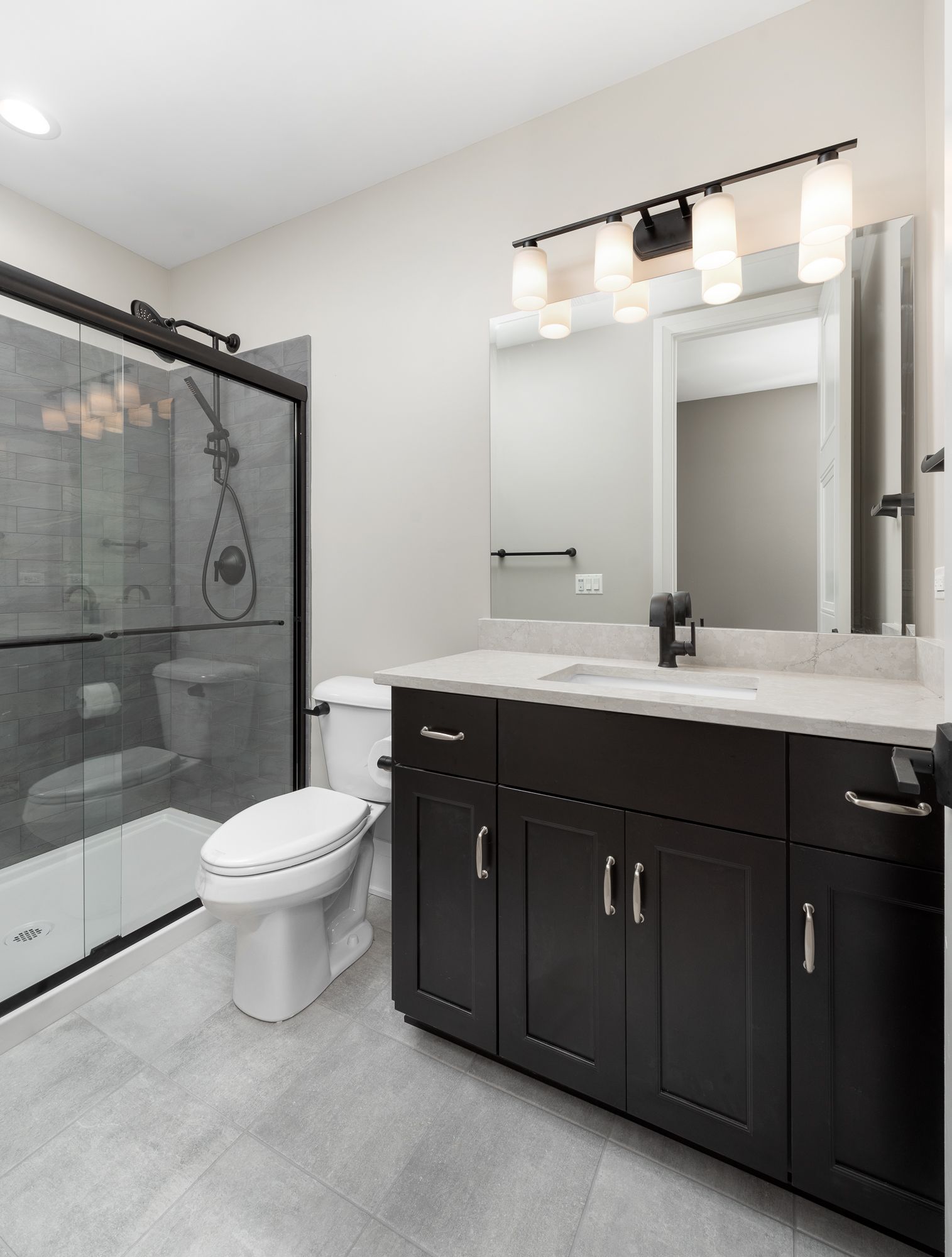 Guest bathroom with sliding glass shower doors and dark wood vanity