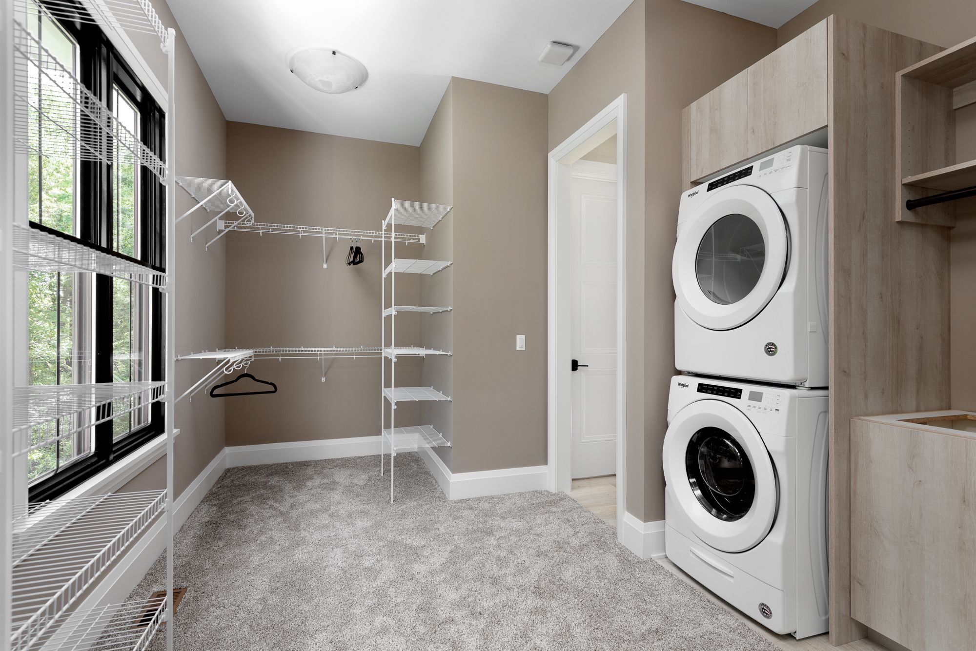 Master bedroom closet with additional washer and dryer and drying racks